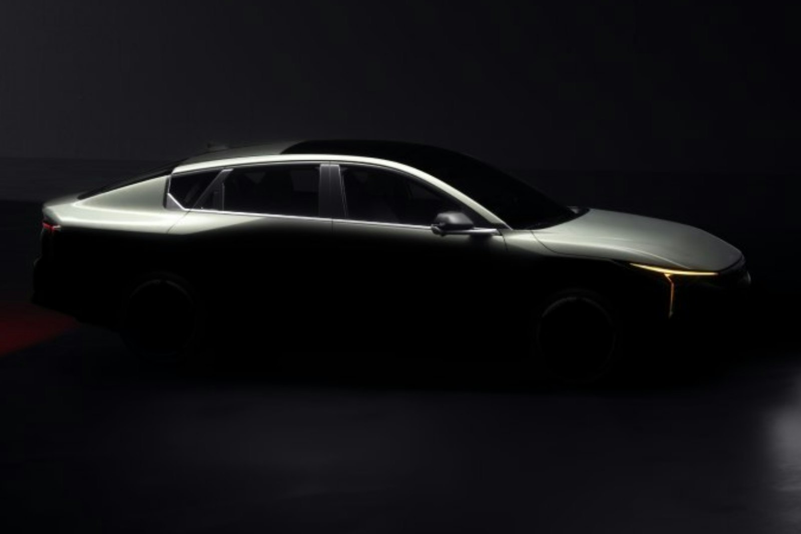 A car at night with its headlight strip lit